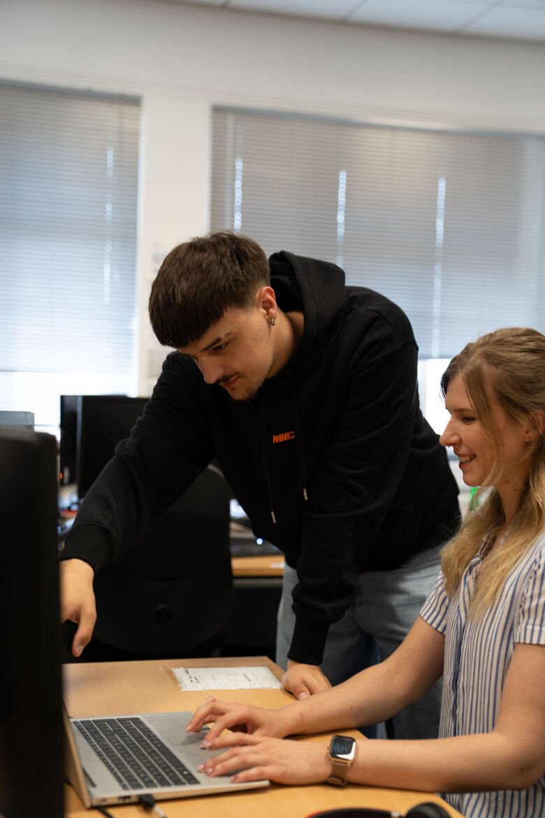 man and woman looking on a screen